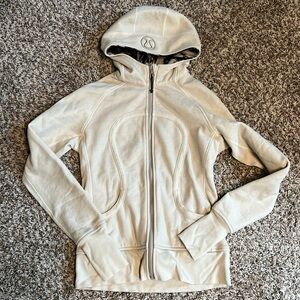 Lululemon Scuba Cream With A Black Pattern In The Hood.